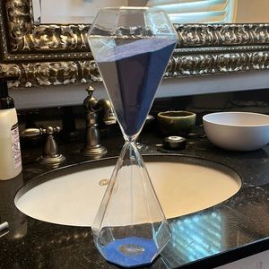Hourglass with blue sand